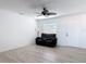Inviting living room features wood flooring, a modern ceiling fan and a cozy reclining sofa at 1767 Valencia Ave, Ormond Beach, FL 32174