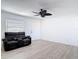 A cozy living room with wood floors, ceiling fan and a comfortable black reclining sofa set at 1767 Valencia Ave, Ormond Beach, FL 32174
