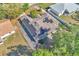 An aerial view showing the roof and solar panels installed on this home surrounded by mature trees at 1877 N Merrick Dr # 0, Deltona, FL 32738