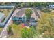 Aerial view of a light blue home with lush landscaping, a well-manicured lawn, and an attached garage at 1877 N Merrick Dr # 0, Deltona, FL 32738