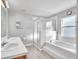 Bright bathroom featuring a double sink vanity, glass enclosed shower and a soaking tub with a window at 1877 N Merrick Dr # 0, Deltona, FL 32738