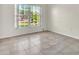 Bedroom featuring tiled floors, a large window overlooking the backyard, and natural light at 1877 N Merrick Dr # 0, Deltona, FL 32738