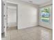 Bedroom with tiled floors, a large window and a doorway to an adjacent room at 1877 N Merrick Dr # 0, Deltona, FL 32738