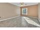 Bright bedroom featuring vinyl floors, neutral walls, a ceiling fan and a window at 1877 N Merrick Dr # 0, Deltona, FL 32738