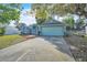 Well-kept blue home featuring an attached two car garage and a long concrete driveway at 1877 N Merrick Dr # 0, Deltona, FL 32738
