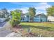 Charming blue home with well-maintained lawn and mature landscaping under a bright blue sky at 1877 N Merrick Dr # 0, Deltona, FL 32738