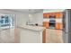 Well-lit kitchen features stainless steel appliances, wood cabinets, and an island sink overlooking the adjoining room at 1877 N Merrick Dr # 0, Deltona, FL 32738