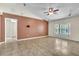 Inviting living room featuring neutral wall color, tile floors, ceiling fan and a bright window at 1877 N Merrick Dr # 0, Deltona, FL 32738