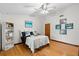 Inviting bedroom featuring hardwood floors, artwork, and a ceiling fan at 1880 N Merrick Dr, Deltona, FL 32738
