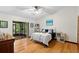 Spacious bedroom with sliding door to screened in lanai and hardwood floors at 1880 N Merrick Dr, Deltona, FL 32738
