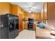Eat-in kitchen with stainless steel appliances, tile floors, and access to backyard at 1880 N Merrick Dr, Deltona, FL 32738