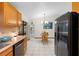 Eat-in kitchen area featuring stainless steel appliances, tiled floors, and large window at 1880 N Merrick Dr, Deltona, FL 32738
