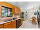 Eat-in kitchen with stainless steel appliances, tile floors, and access to backyard at 1880 N Merrick Dr, Deltona, FL 32738
