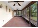 Spacious screened-in porch with ceiling fans, offering a comfortable outdoor living space at 1880 N Merrick Dr, Deltona, FL 32738