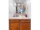Compact wet bar with wooden cabinets, a small sink, and decorative accents at 1880 N Merrick Dr, Deltona, FL 32738