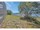 Spacious backyard with a black chain-link fence, leading to a serene view of the water at 1963 Stacey Cir, Deltona, FL 32738