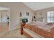 Cozy bedroom featuring a ceiling fan, light beige walls, carpet, and entertainment center at 1963 Stacey Cir, Deltona, FL 32738
