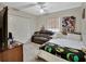Well-lit bedroom with ceiling fan, double closet, love seat, and neutral decor at 1963 Stacey Cir, Deltona, FL 32738