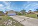 Well-maintained home with a spacious driveway, two-car garage, and neatly manicured lawn at 1963 Stacey Cir, Deltona, FL 32738