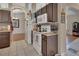 Kitchen with white appliances, brown cabinets, tile flooring, and mosaic backsplash at 1963 Stacey Cir, Deltona, FL 32738