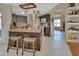 Bright kitchen featuring an island with seating, brown cabinets, and open layout at 1963 Stacey Cir, Deltona, FL 32738