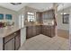 Well-lit kitchen featuring brown cabinets, a cream countertop, and tile flooring at 1963 Stacey Cir, Deltona, FL 32738