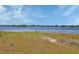 Scenic lake view with clear blue skies and lush greenery, perfect for nature enthusiasts at 1963 Stacey Cir, Deltona, FL 32738