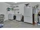 Functional laundry room with washer, dryer, shelving, and large freezer at 1963 Stacey Cir, Deltona, FL 32738