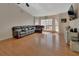 Spacious living room with hardwood floors, large windows, and a comfortable leather sofa at 1963 Stacey Cir, Deltona, FL 32738