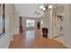 Open-concept living space with hardwood floors connecting the living room, dining area, and kitchen at 1963 Stacey Cir, Deltona, FL 32738