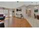 Well-lit living room with hardwood floors, large windows, and view into dining room at 1963 Stacey Cir, Deltona, FL 32738