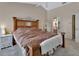 Cozy main bedroom with a large bed, neutral color palette, and bathroom access at 1963 Stacey Cir, Deltona, FL 32738