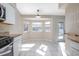 Bright kitchen with white cabinetry, stainless steel appliances, granite countertops, and a bay window at 201 Williams Ave, Orange City, FL 32763