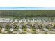 Aerial shot showcases the home's location within a peaceful community near a serene lake at 214 Caryota Ct, New Smyrna Beach, FL 32168