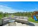 Outdoor patio with comfortable seating, scenic lake views, and a playground nearby at 214 Caryota Ct, New Smyrna Beach, FL 32168