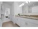 Elegant bathroom featuring double vanity with granite countertop and well lit mirror at 214 Caryota Ct, New Smyrna Beach, FL 32168