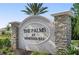 Elegant entrance sign for The Palms at Venetian Bay, featuring stone pillars and lush landscaping at 214 Caryota Ct, New Smyrna Beach, FL 32168