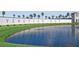 Venetian Bay community entrance featuring lush landscaping and a tranquil lake at 214 Caryota Ct, New Smyrna Beach, FL 32168