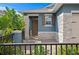 Inviting covered front porch with decorative stone pillars and detailed trim work create a warm welcome at 214 Caryota Ct, New Smyrna Beach, FL 32168