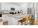 Bright, modern kitchen with stainless steel appliances, granite countertops, and stylish bar stool seating at 214 Caryota Ct, New Smyrna Beach, FL 32168