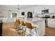 Stylish kitchen with granite counters, bar seating, and stainless steel appliances open to living space at 214 Caryota Ct, New Smyrna Beach, FL 32168