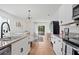 Open concept kitchen featuring white cabinets, stainless steel appliances, and seamless flow to living area at 214 Caryota Ct, New Smyrna Beach, FL 32168