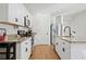 Bright kitchen featuring granite countertops, stainless steel appliances, and white cabinetry at 214 Caryota Ct, New Smyrna Beach, FL 32168