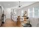 Sunlit open floor plan with a dining area and living room featuring large windows at 214 Caryota Ct, New Smyrna Beach, FL 32168