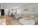 Cozy open-concept living room featuring a comfortable sectional couch and modern decor at 214 Caryota Ct, New Smyrna Beach, FL 32168