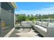 Elegant outdoor living space featuring comfortable seating overlooking a serene lake, offering a relaxing retreat at 214 Caryota Ct, New Smyrna Beach, FL 32168