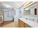Well-lit bathroom with vanity, large mirror, and a separate shower stall at 24919 Drive No 1, Astor, FL 32102