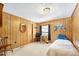 Comfortable bedroom with vintage wood paneling and a cozy, twin bed at 24919 Drive No 1, Astor, FL 32102