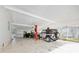 Spacious carport features a car lift, room for vehicles, and ample storage, perfect for hobbyists at 24919 Drive No 1, Astor, FL 32102