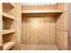 Empty closet with wood paneled walls and shelving for optimal storage at 24919 Drive No 1, Astor, FL 32102